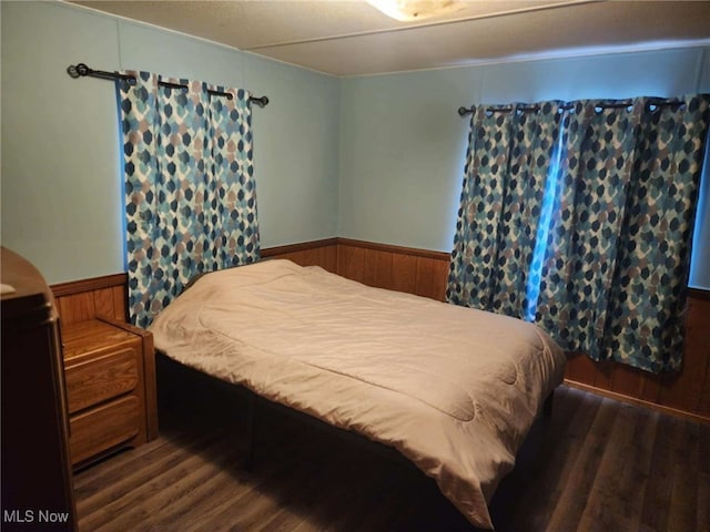 bedroom with dark wood-type flooring