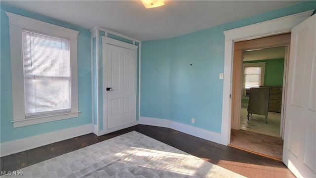 interior space featuring a wealth of natural light and dark hardwood / wood-style floors