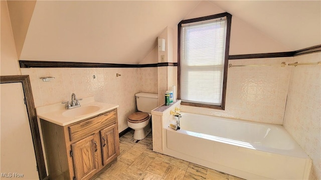 119 Euclid Pl, Marietta, OH 45750 - bathroom featuring a bath, vanity, tile walls, healthy amount of natural light, and vaulted ceiling