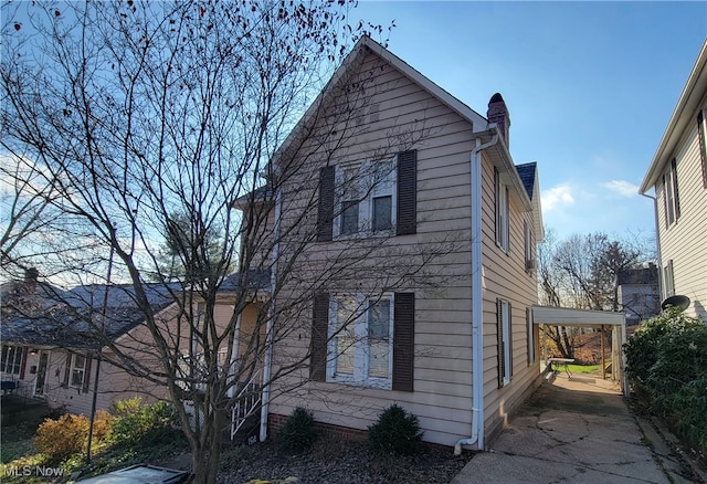 view of side of home with a carport