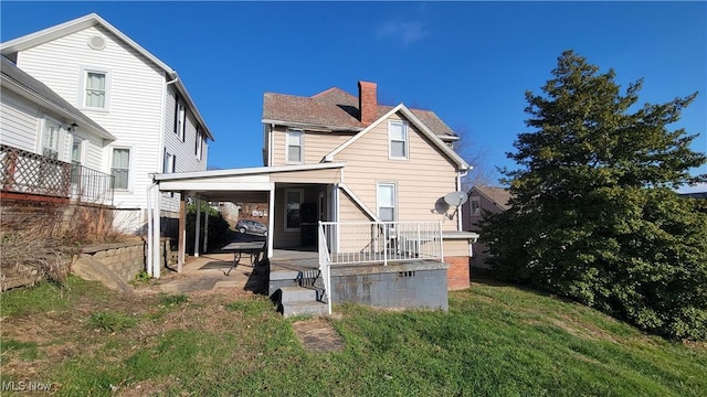 119 Euclid Pl, Marietta, OH 45750 - back of property with a patio area, a chimney, and a lawn