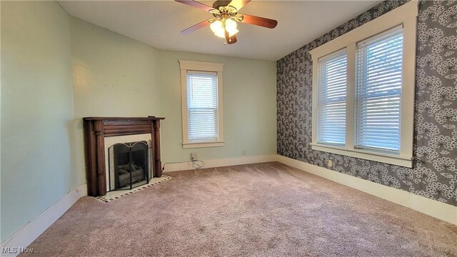 119 Euclid Pl, Marietta, OH 45750 - unfurnished living room with wallpapered walls, carpet, a fireplace with flush hearth, and a ceiling fan