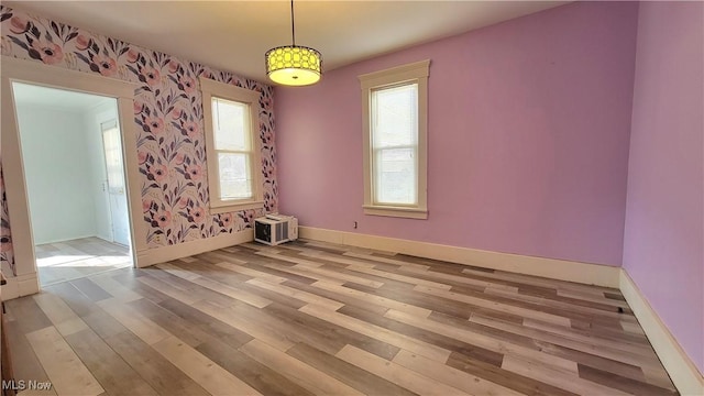 119 Euclid Pl, Marietta, OH 45750 - unfurnished room featuring light wood-style flooring, wallpapered walls, healthy amount of natural light, and an AC wall unit