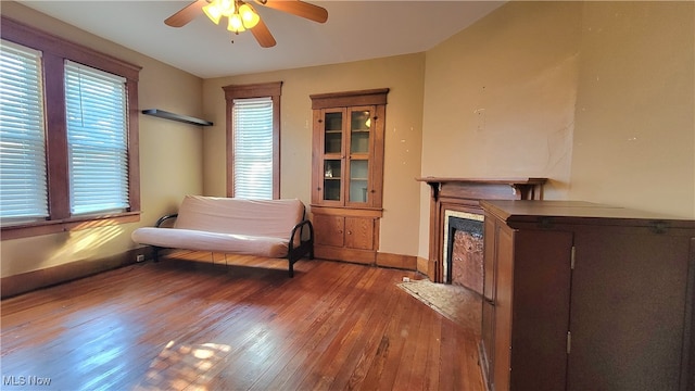 sitting room featuring ceiling fan and wood-type flooring