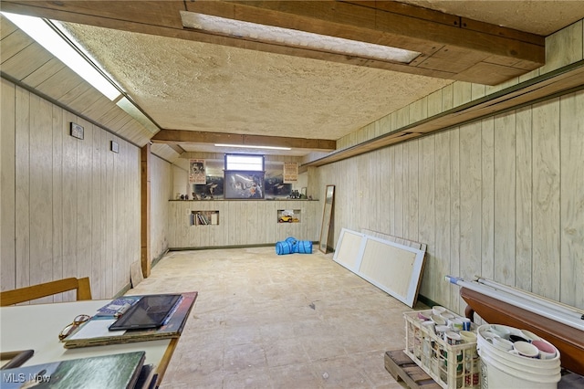 basement featuring wood walls