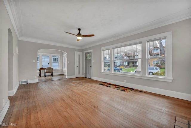 unfurnished living room with light wood-type flooring, ceiling fan, and crown molding