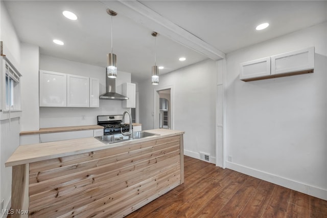 kitchen with dark wood-type flooring, white cabinets, sink, hanging light fixtures, and stainless steel range with gas stovetop