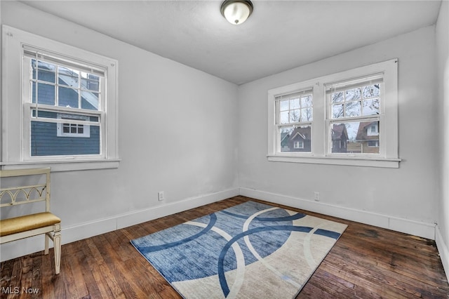 unfurnished room with dark wood-type flooring