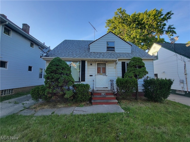 bungalow-style home with a front yard