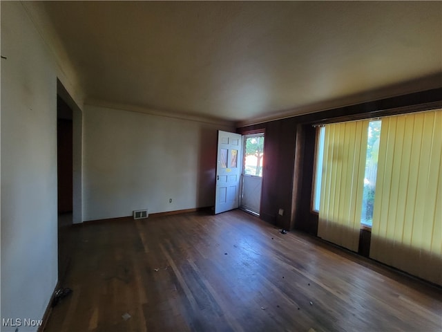 empty room with dark hardwood / wood-style flooring