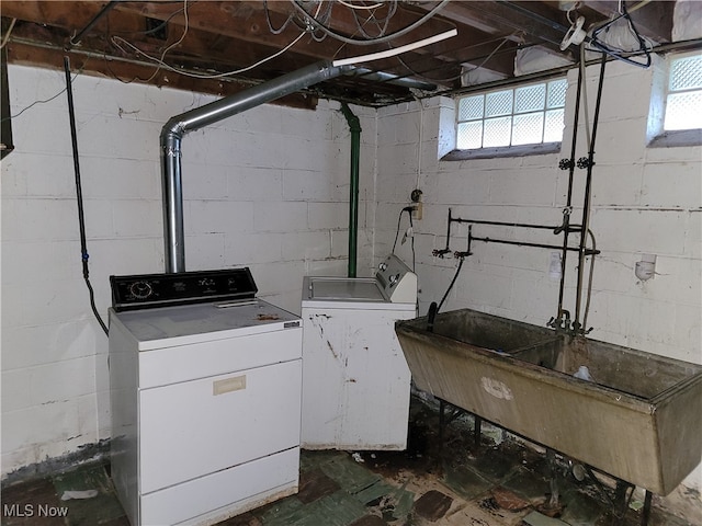 clothes washing area featuring separate washer and dryer