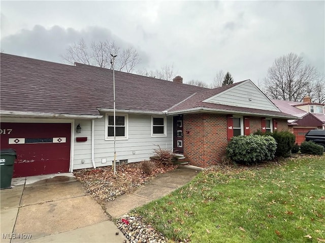 single story home with a garage and a front lawn