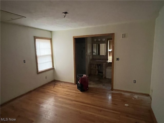 unfurnished room with wood-type flooring