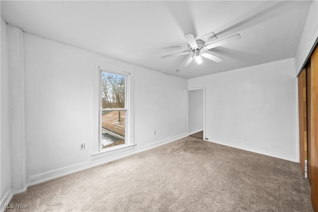 spare room with carpet and ceiling fan