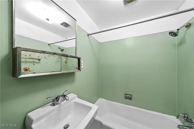 bathroom with sink and shower / washtub combination