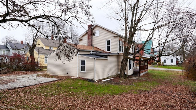 rear view of house featuring a yard