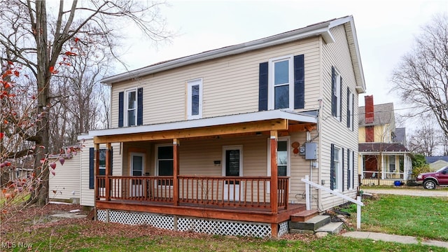 country-style home with a porch and a front lawn