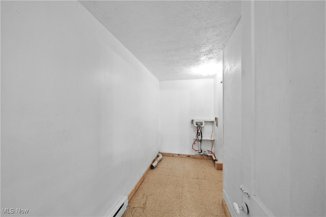 clothes washing area with a textured ceiling