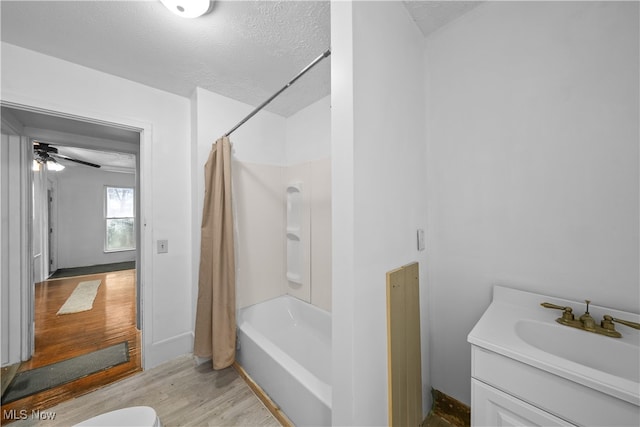 full bathroom with vanity, a textured ceiling, shower / tub combo with curtain, ceiling fan, and hardwood / wood-style floors