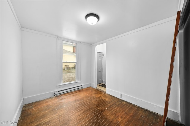 spare room with a baseboard radiator and dark wood-type flooring