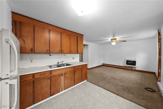 kitchen featuring light carpet, heating unit, ceiling fan, sink, and white refrigerator