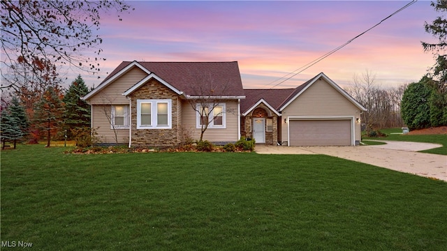 view of front facade with a lawn and a garage