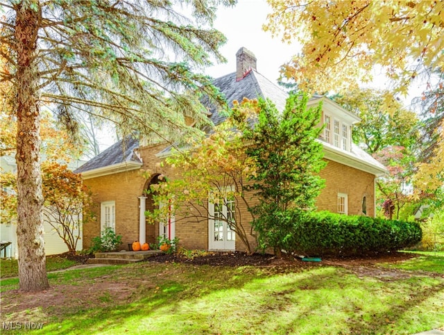 view of front facade featuring french doors and a front yard