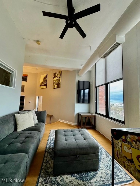 living room with ceiling fan and light wood-type flooring