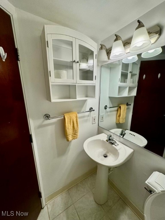 bathroom featuring tile patterned flooring and sink