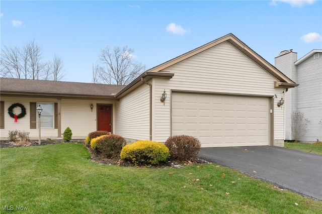 single story home featuring a front yard and a garage