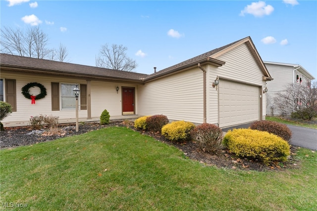 single story home featuring a front yard and a garage