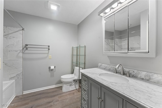 full bathroom with toilet, vanity, tiled shower / bath combo, and hardwood / wood-style flooring