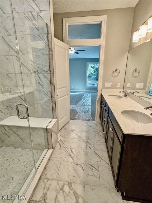 bathroom with ceiling fan, vanity, and a shower with shower door