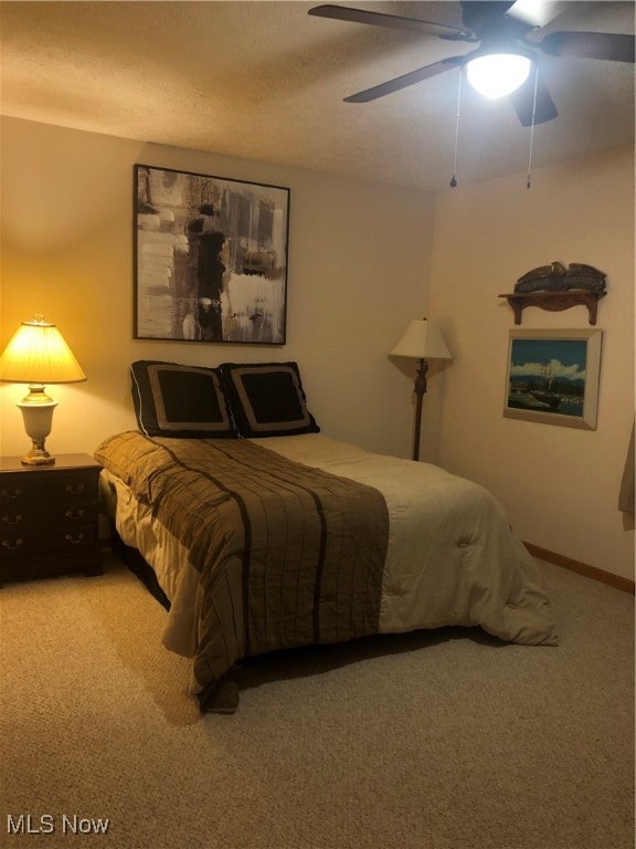 bedroom featuring ceiling fan and carpet floors