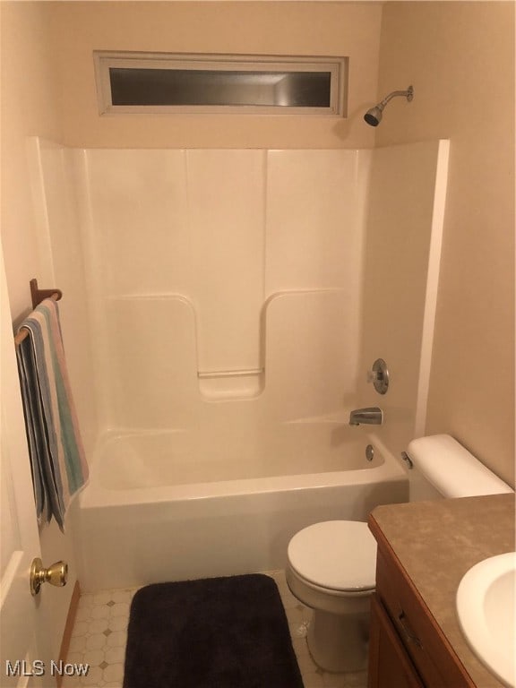 full bathroom featuring tile patterned floors, vanity, toilet, and shower / washtub combination