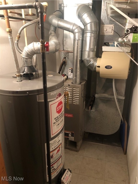 utility room featuring water heater