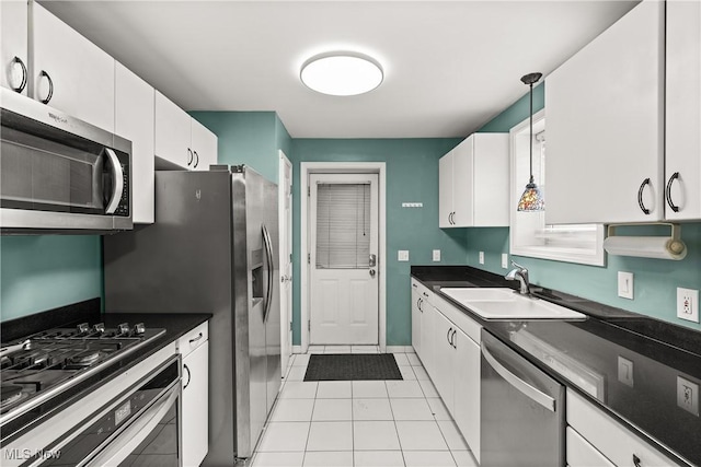 kitchen with white cabinetry, sink, stainless steel appliances, and decorative light fixtures