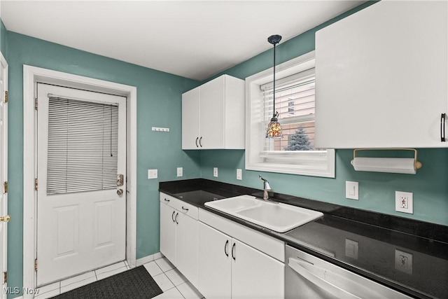 kitchen with sink, pendant lighting, light tile patterned floors, dishwasher, and white cabinetry