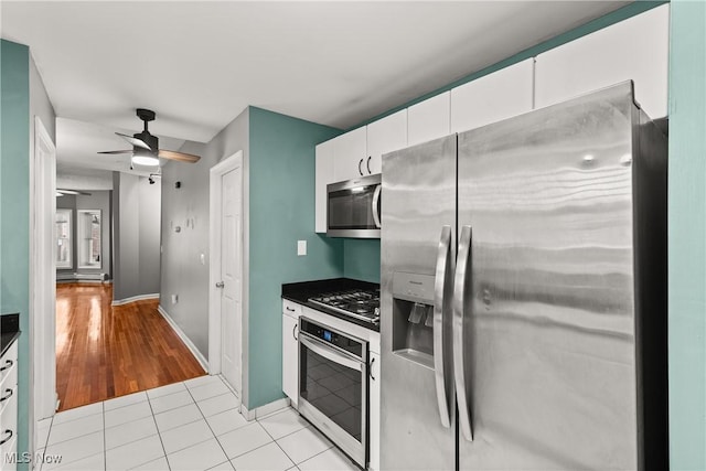 kitchen featuring ceiling fan, white cabinets, light hardwood / wood-style floors, and appliances with stainless steel finishes