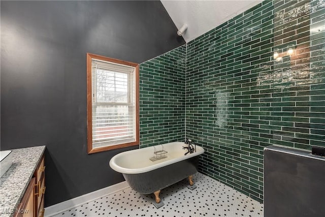 bathroom featuring a washtub and vanity