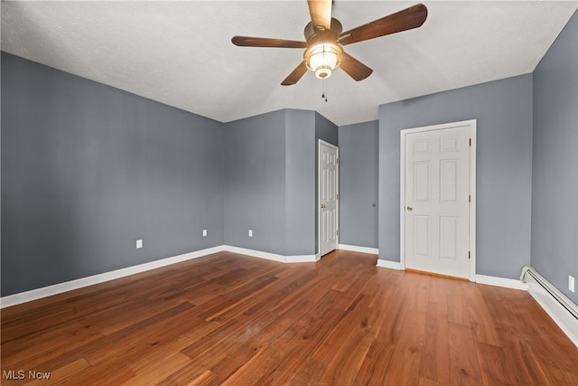 unfurnished bedroom featuring wood-type flooring, a textured ceiling, a baseboard radiator, and ceiling fan