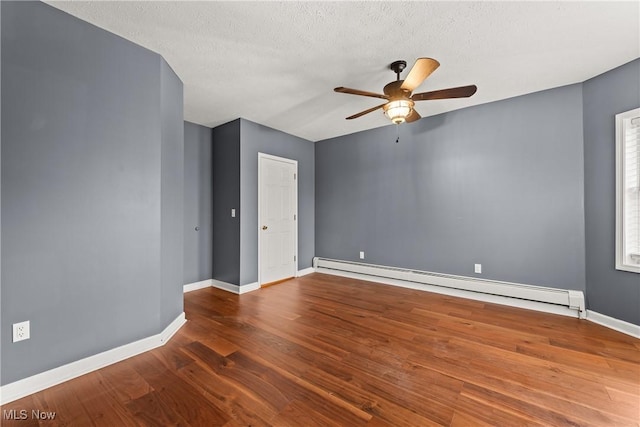 unfurnished room featuring hardwood / wood-style floors, a textured ceiling, ceiling fan, and a baseboard heating unit