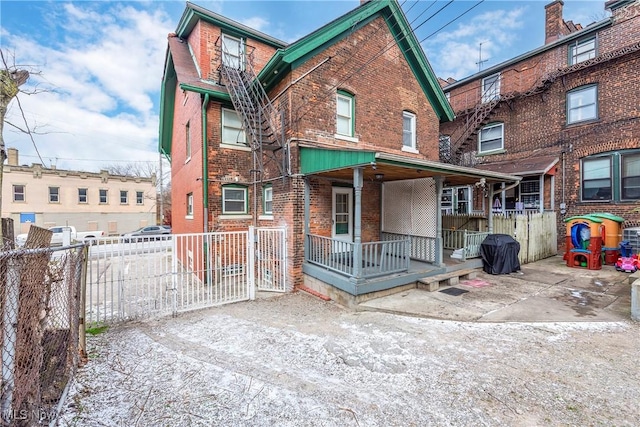 rear view of property with a porch