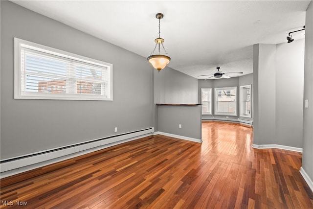 interior space featuring ceiling fan, a baseboard radiator, and hardwood / wood-style flooring