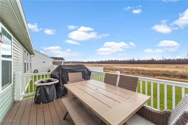 deck featuring a rural view and a lawn