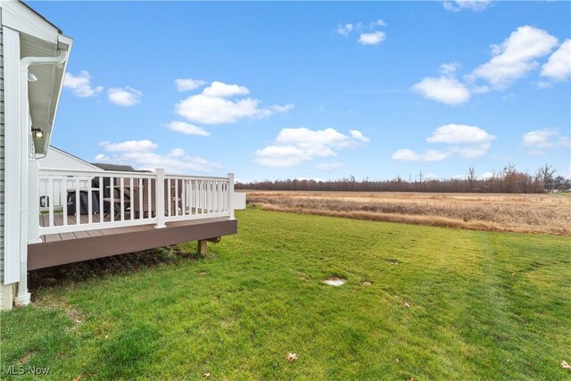 view of yard featuring a rural view and a deck