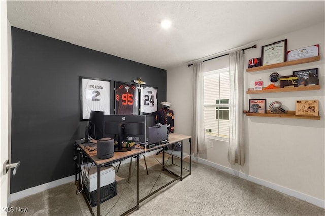 carpeted office space featuring a textured ceiling