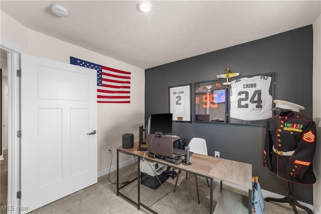 carpeted office space with a textured ceiling