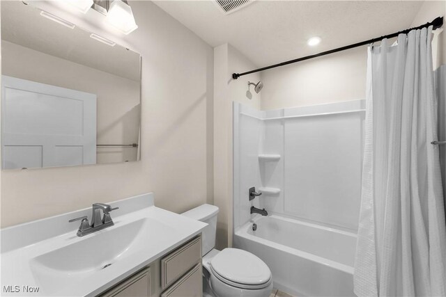 full bathroom featuring vanity, shower / bath combination with curtain, and toilet