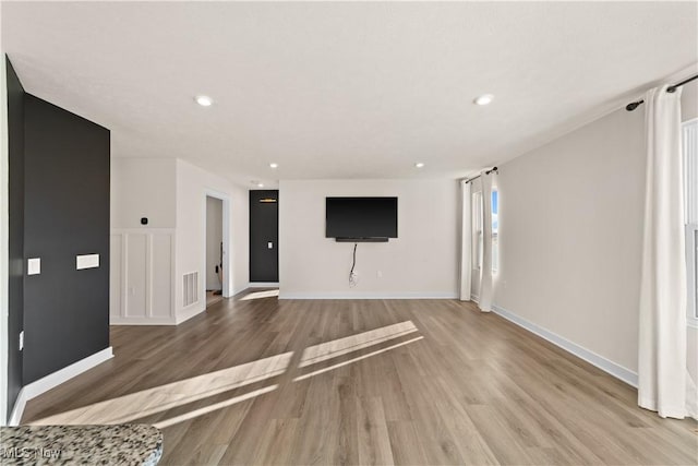 unfurnished living room with light hardwood / wood-style floors